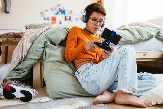 Teen Gamer Playing Videogame On Smartphone