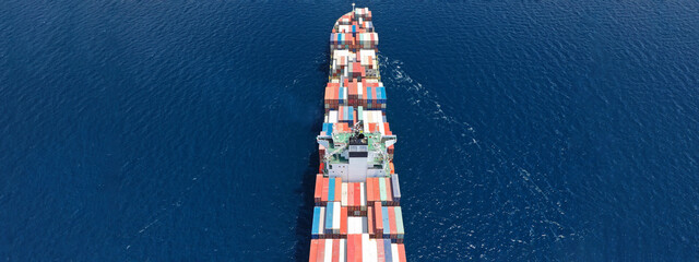 Aerial drone ultra wide panoramic photo of colourful truck size container tanker ship cruising deep...