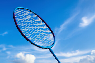 Badminton racket on blue sky. Badminton open air game activity. Badminton outdoor sport playing