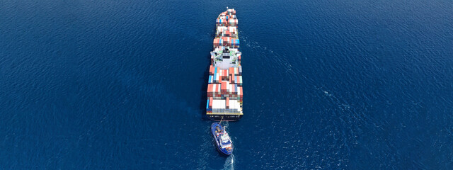 Aerial drone ultra wide panoramic photo of colourful truck size container tanker ship cruising deep...