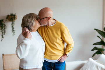 Senior couple kissing at home