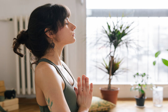 Close up image of a young woman who meditates during a yoga class 