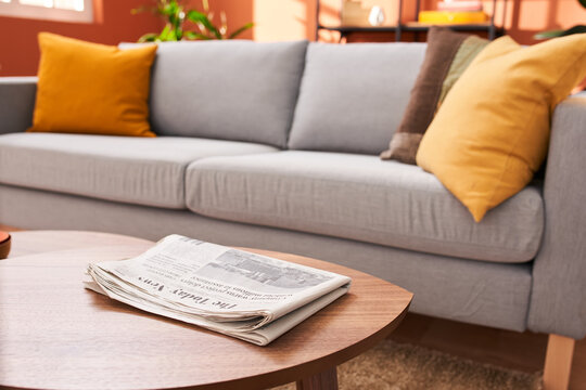 Newspaper on table near sofa