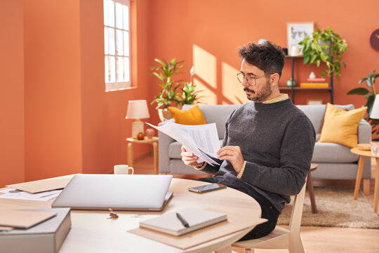 Man checking documents near table