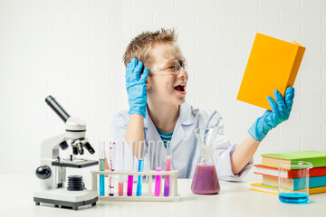 Funny boy dressed as chemist with dirty face after a failed experiment