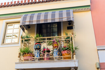 Beautiful vintage balcony with colorful flowers and doors