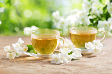cups of jasmine tea and fresh jasmine flowers