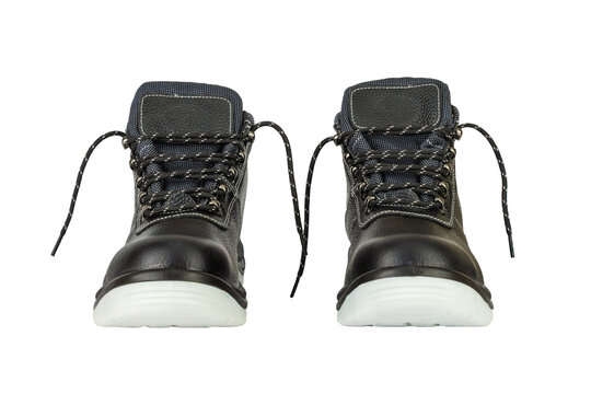 A pair of black leather work boots with thick gray soles on a white background. Front view. The shoes are new and clean. The laces are untied. The image is isolated. Boots in the center.