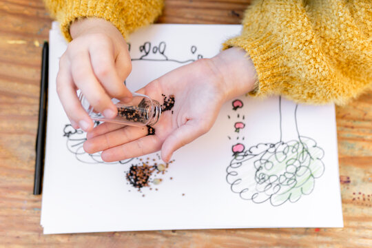 Close-up of kid girl selecting seeds to plant 