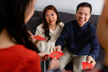 Parents Giving Children Red Envelopes on Chinese New Year