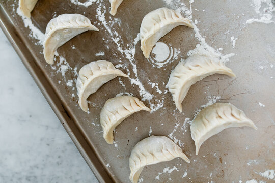 Dumplings Lined On a Baking Sheet