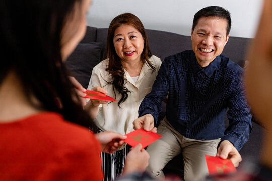 Parents Giving Children Red Envelopes on Chinese New Year