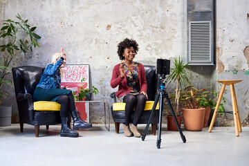 Multiethnic women greeting online colleagues