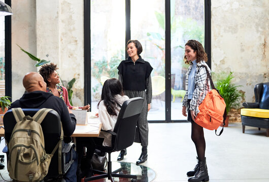 Diverse team greeting new colleague