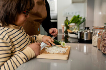 man and son cooking at home