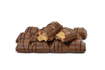 Black chocolate bar with soft hazelnut filling isolated on white background.