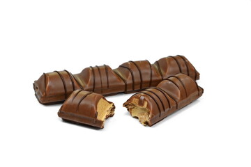 Black chocolate bar with soft hazelnut filling isolated on white background.