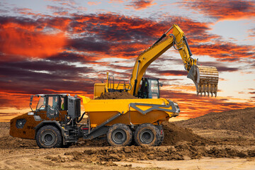 Fototapeta na wymiar earth mover and excavator at work in construction site