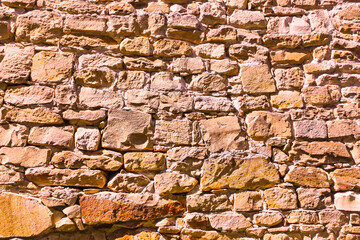 Texture brown old stone castle defense wall.