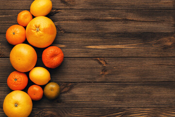 Citrus grapefruit, orange, tangerine on a background of wooden boards.