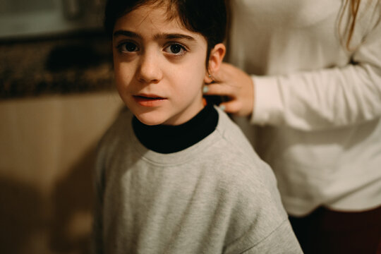 Older sister combing her sister's hair before going to school