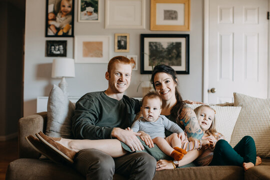 Happy Family with Two Young Children in Living Room
