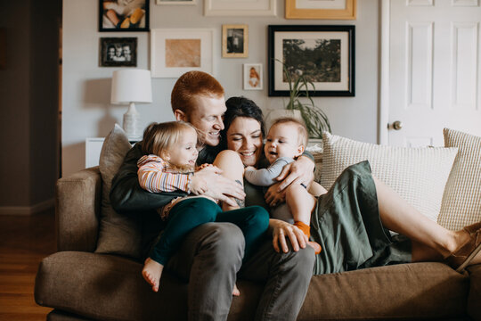 Happy Family with Two Young Children in Living Room