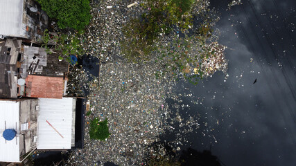 Aerial view of high quantities of trash inside a canal near Negro River, downtown Manaus, located in Amazonas state, Brazil.