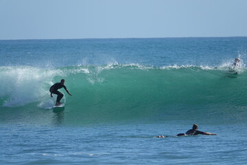 Jim surfing on a clear blue sunny day