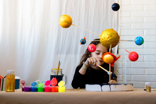 Young girl doing a handmade Solar System Craft For Science