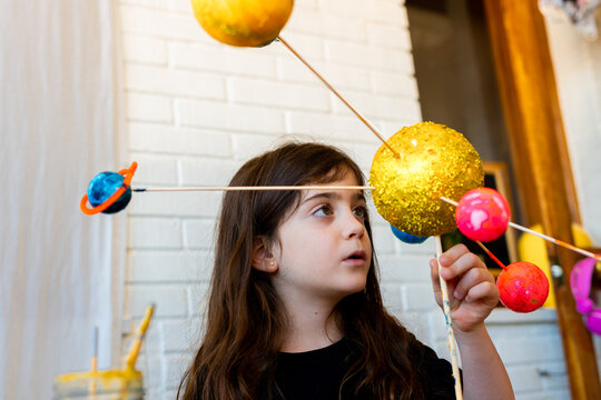 Little girl doing a handmade Solar System Craft For Science