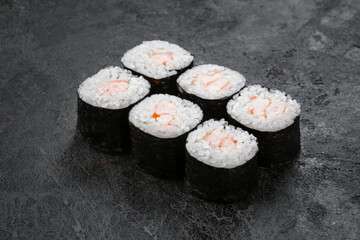 Sake maki Japanese roll with shrimp on stone. Ebi sushi-roll, close up