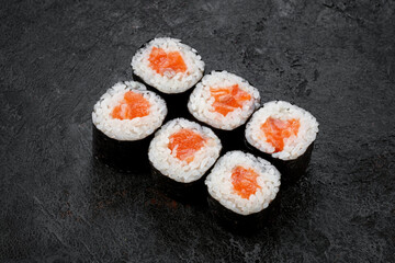 Sake maki Japanese roll with Salmon on stone. sushi-roll