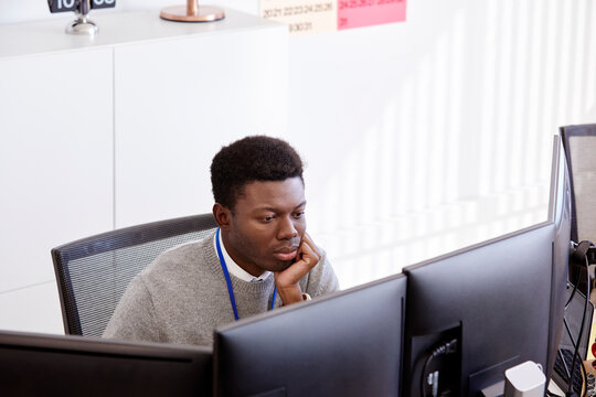 Black businessman looking at computer screen