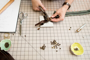 Artisan working on leather zipper pull