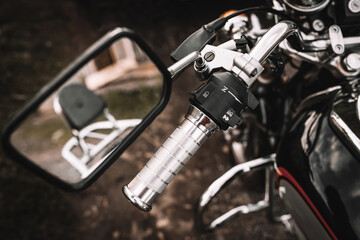 Motorcycle detail with handlebar and mirror. Chrome motorcycle details closeup.