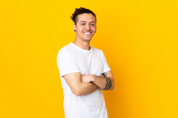 Caucasian man over isolated background with arms crossed and looking forward