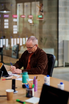 Senior employee writing report