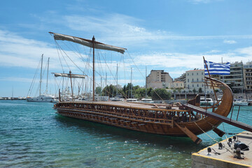 Athenian Trireme masterpiece replica "OLYMPIAS"of ancient warship of 5th BC century, moored at port and Marina of Zea next to busy port of Piraeus, Attica, Greece