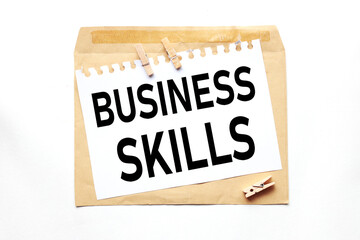 BUSINESS SKILLS. text on white paper on craft notebook