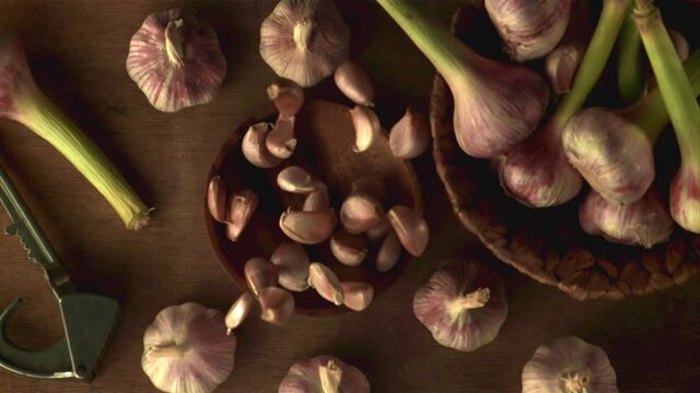 Super slow motion plate with garlic falls on a gray background. Filmed on a high-speed camera, 1000 fps. High quality FullHD footage