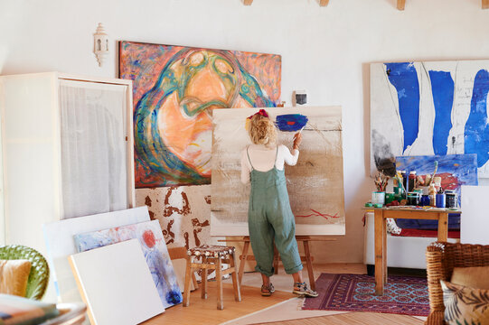 Senior woman painting in her art studio