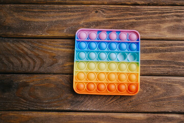 Children's toy 'simple dimple' on a wooden table.