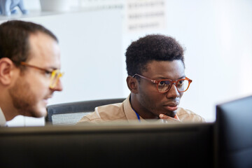 Big data analysts looking at computer screen