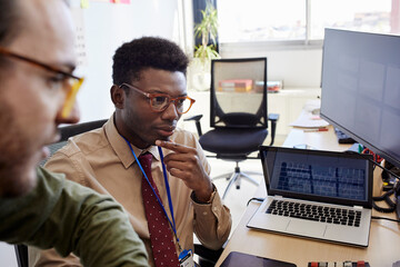 Big data analysts looking at computer screen