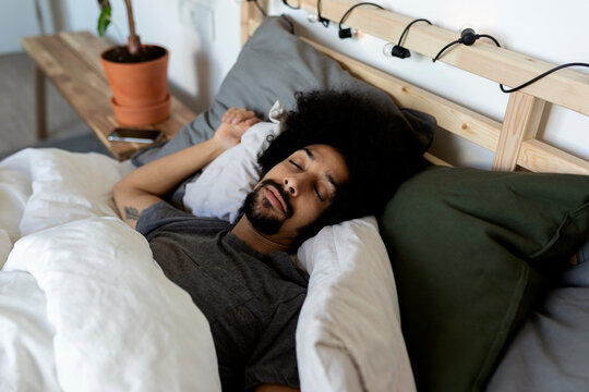 man sleeping in bed