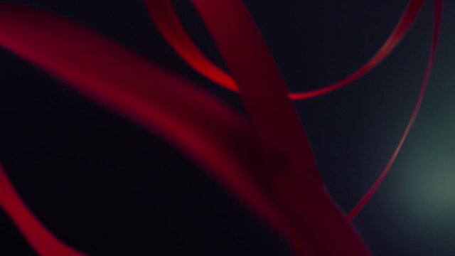 Unknown athlete exercising gymnastic ribbon. Unrecognizable hand swirling tape