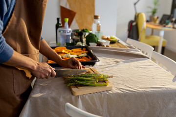 man cooking vegan food at home