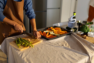 man cooking vegan food at home