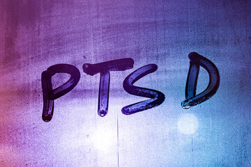 abbreviation ptsd - post traumatic stress disorder - handwritten on night wet window glass